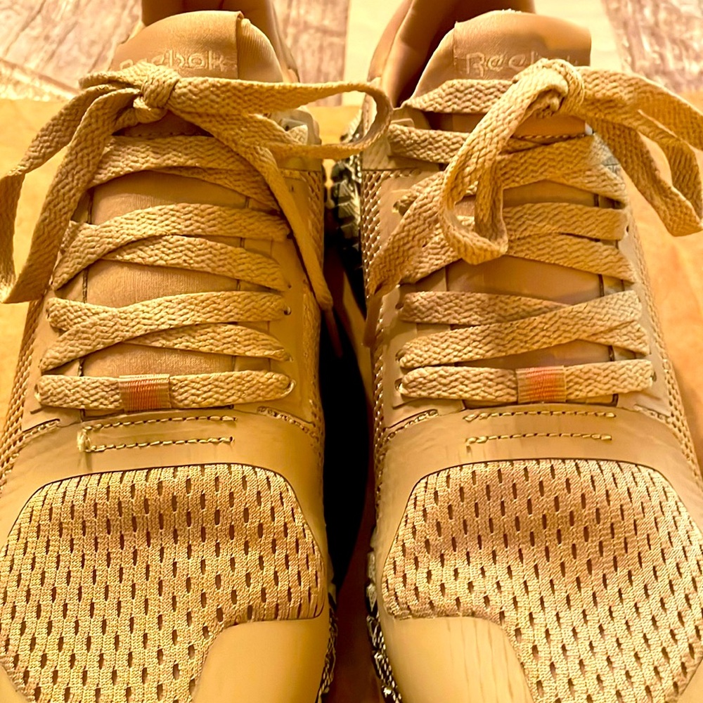 Women’s Reebok sneaker,
 beige color with animal print bottom.